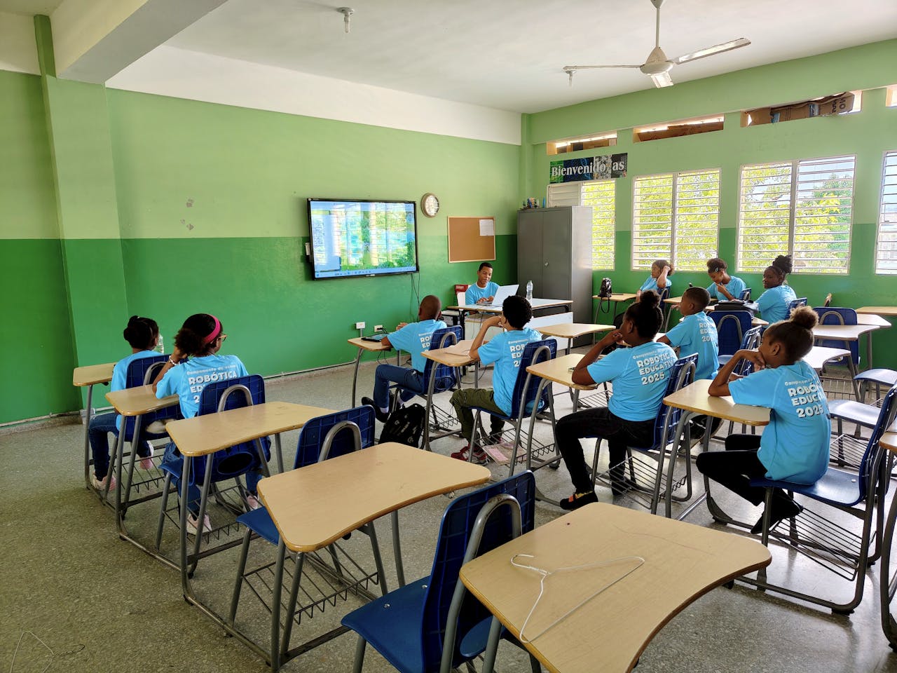 Students engage in a digital learning session in a bright, modern classroom with educational technology.